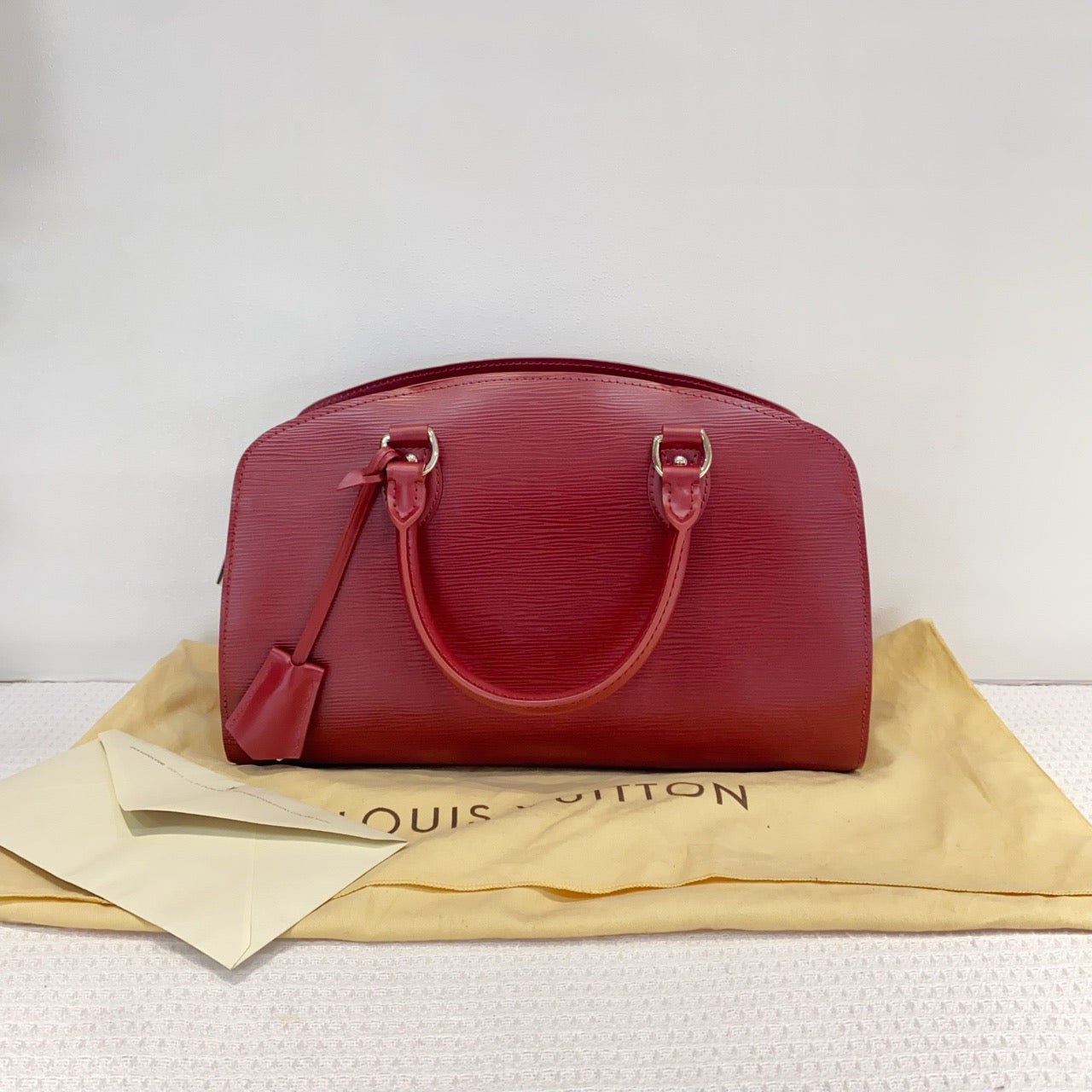 Louis Vuitton red water ripple handbag