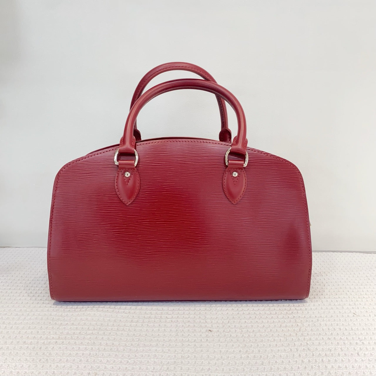 Louis Vuitton red water ripple handbag